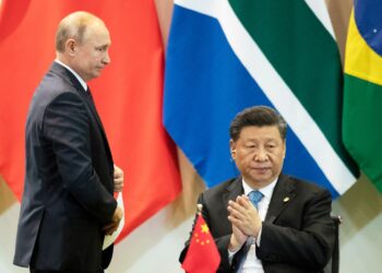 China's President Xi Jinping, right, and Russia's President Vladimir Putin attend a meeting with members of the Business Council and management of the New Development Bank during the BRICS emerging economies at the Itamaraty palace in Brasilia, Brazil, Thursday, Nov. 14, 2019. (AP Photo/Pavel Golovkin, Pool)
