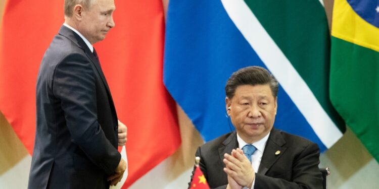 China's President Xi Jinping, right, and Russia's President Vladimir Putin attend a meeting with members of the Business Council and management of the New Development Bank during the BRICS emerging economies at the Itamaraty palace in Brasilia, Brazil, Thursday, Nov. 14, 2019. (AP Photo/Pavel Golovkin, Pool)
