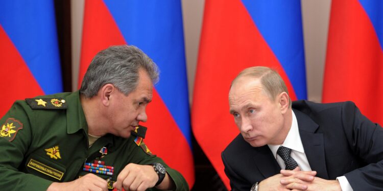 FILE - In this Friday, Nov. 15, 2013 file photo Russian President Vladimir Putin, right, and Defense Minister Sergei Shoigu attend a meeting while visiting the airborne troops school in the city of Ryazan, some 100 km (62.5 miles) southeast of Moscow, Russia. President Vladimir Putin on Wednesday, Feb. 26, 2014, ordered massive exercises involving most of its military units in western Russia amid tensions in Ukraine. (AP Photo/RIA-Novosti, Alexei Nikolsky, Presidential Press Service, File)