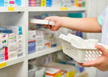Pharmacist filling prescription in pharmacy drugstore