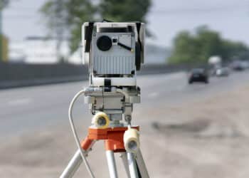 Traffic speed control camera radar installed by side of the road. Video camera is recording violations. CCTV
